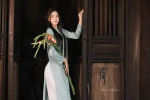 Elegant Ao Dai Beauty: Vietnamese Girl's Grace with Flowers in a Classic Setting - image 5