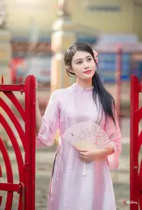 VGU No.163: The Graceful Beauty of a Vietnamese Girl in Traditional Pink Ao Dai Amidst Ancient Architecture - image 0