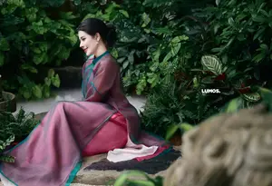 Graceful East Asian Beauty: Traditional Charm in a Lush Green Garden - image 0